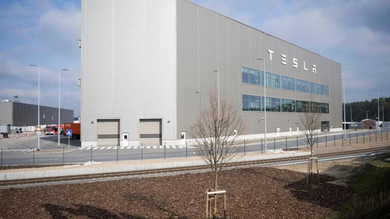 Production at Tesla's plant in Germany is halted after a power outage. Officials suspect arson