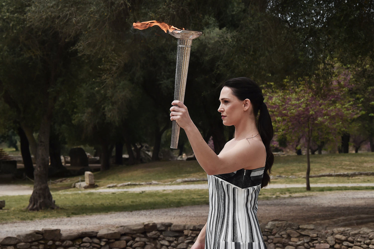 Paris flame lit in ancient Olympia ceremony, starting torch relay to France