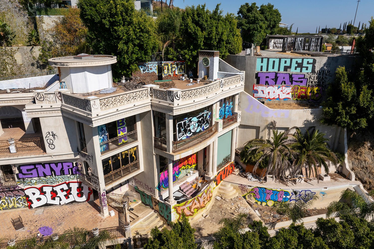 Two abandoned mansions owned by a Hollywood producer are covered in graffiti